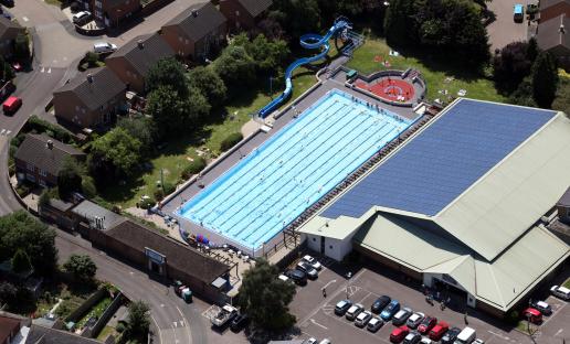 Aerial view of Banbury Leisure Centre with outdoor pool and solar panels.