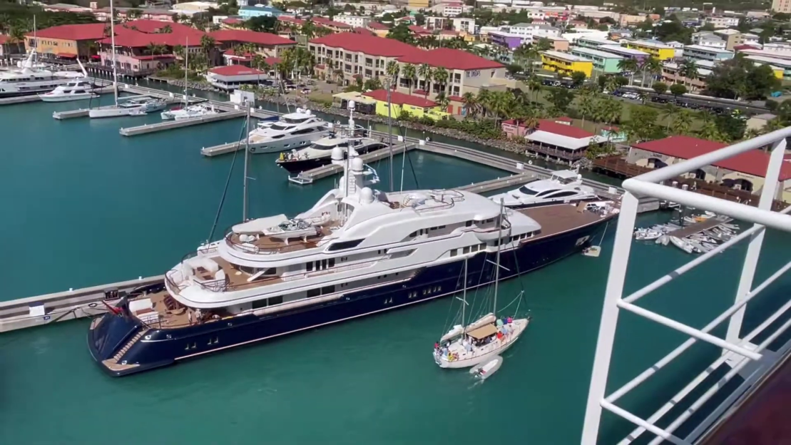 Aerial view of the Hampshire II luxury mega yacht docked in a marina.