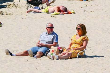 Couple relaxing on a sunny beach.