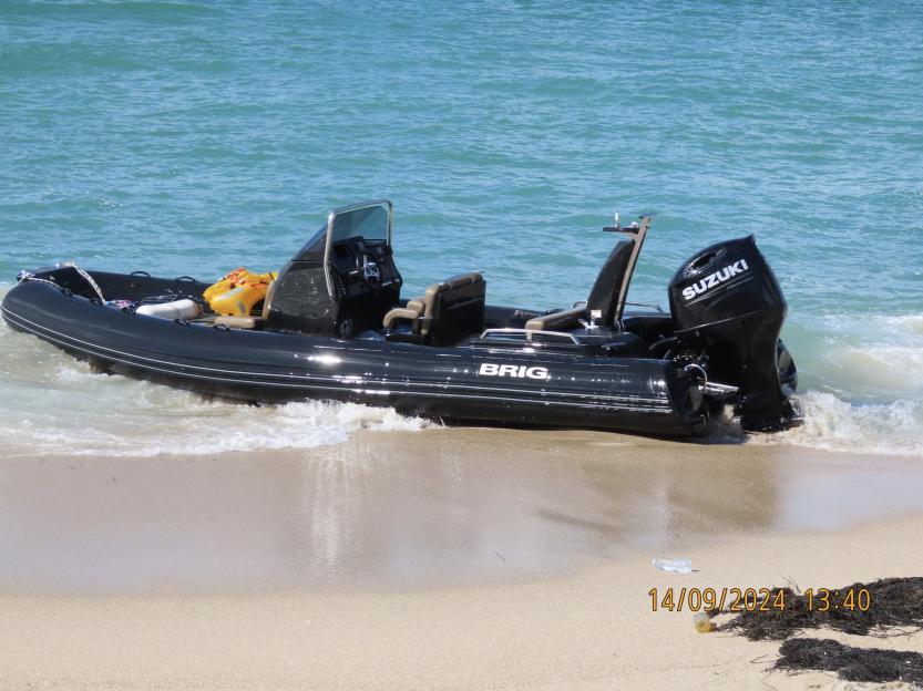 Seized cocaine smuggling boat on a beach.