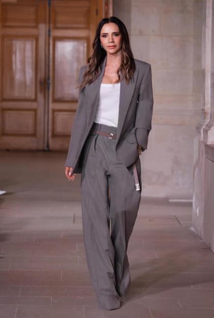 Victoria Beckham walking the runway in a gray suit and white top at Val-de-Grâce.