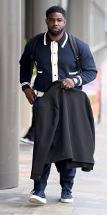 Micah Richards carrying a jacket.