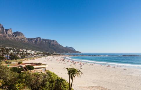 Camps Bay beach in Cape Town, South Africa, with Table Mountain in the background.
