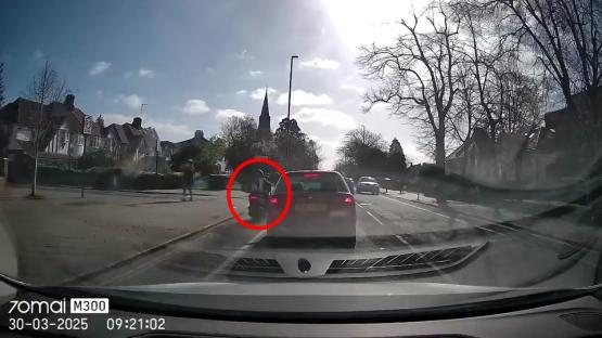 Dashcam footage of a moped colliding with a car.