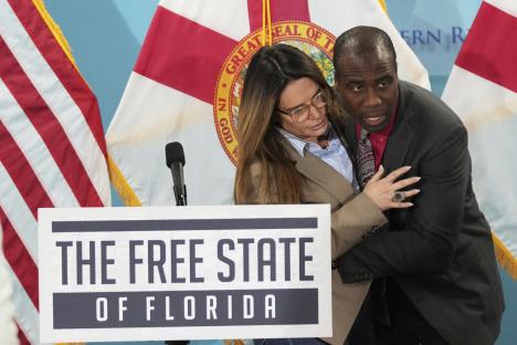Florida Surgeon General Dr. Joseph Ladapo assisting Florida State Senator Ileana Garcia.