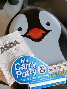A My Carry Potty penguin-shaped potty trainer with an ASDA receipt.