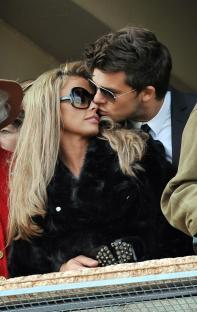 Katie Price and Leandro Penna kissing in the Royal Box at Cheltenham Racecourse.