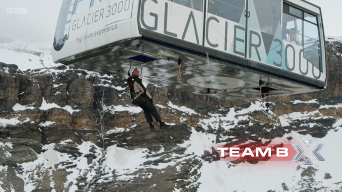 Person rappelling from a Glacier 3000 cable car.