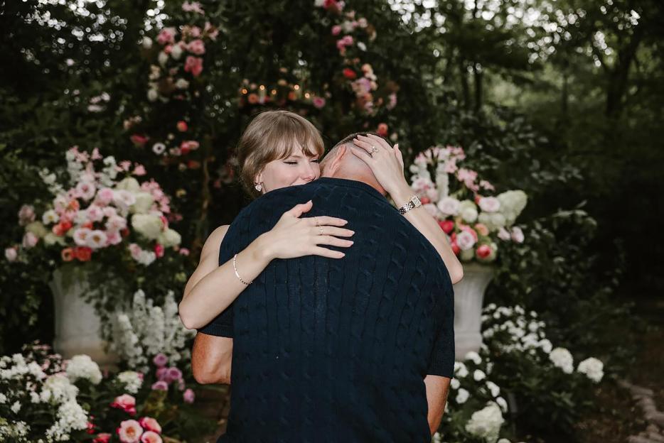 Taylor Swift and Travis Kelce embracing after an engagement.