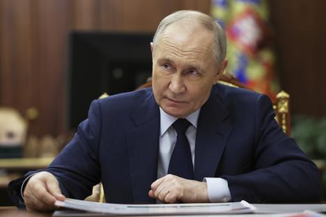 Vladimir Putin listening attentively.