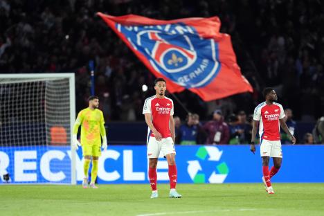 Arsenal players look dejected after Paris Saint-Germain scores.