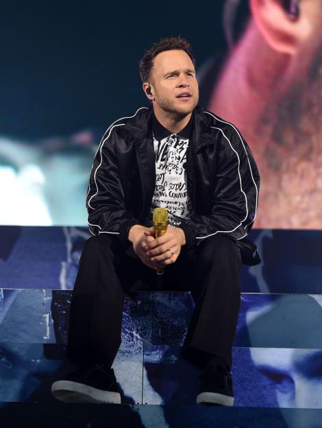 Olly Murs performing on stage.