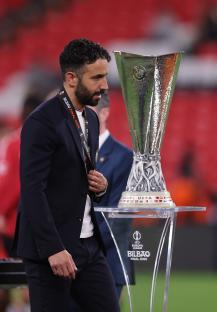 Ruben Amorim, Manchester United manager, looking dejected near the UEFA Europa League trophy.
