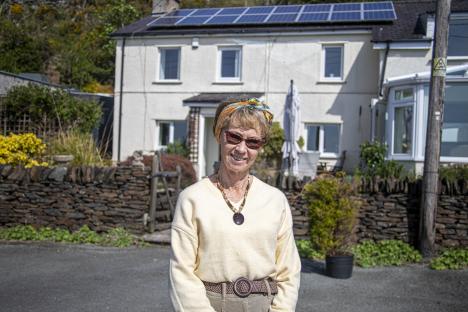 Woman standing in front of her home near a quarry.