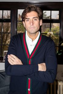 Portrait of James Argent with arms crossed.