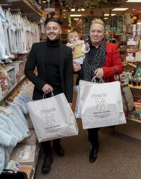 Barrie Drewitt Barlow and Scott Hutchison with their daughter Valentina shopping for baby items.