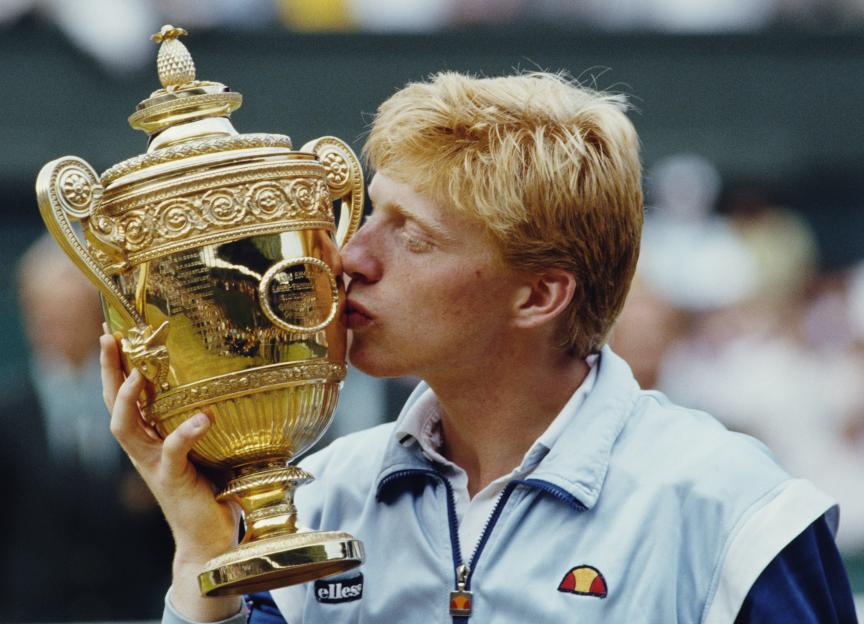 Boris Becker kissing the Wimbledon Gentlemen's Singles Championship trophy after his 1985 victory.
