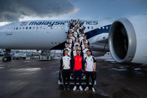Manchester United soccer team boarding a plane.