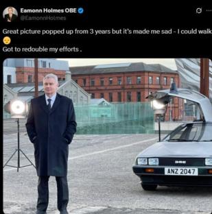 Screenshot of a tweet showing Eamonn Holmes standing next to a DeLorean.