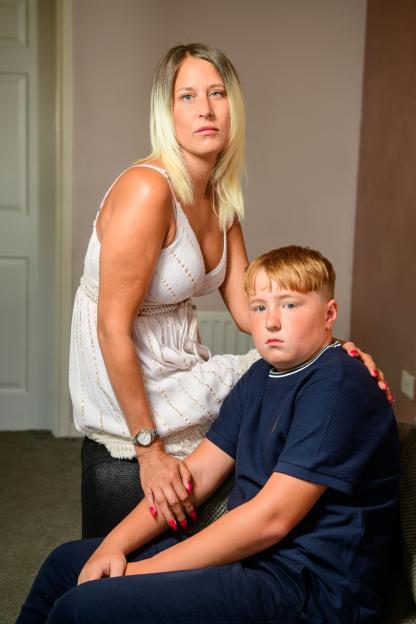 A mother and her son sit together at home.