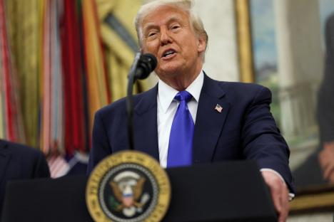 President Donald Trump speaking at a podium.