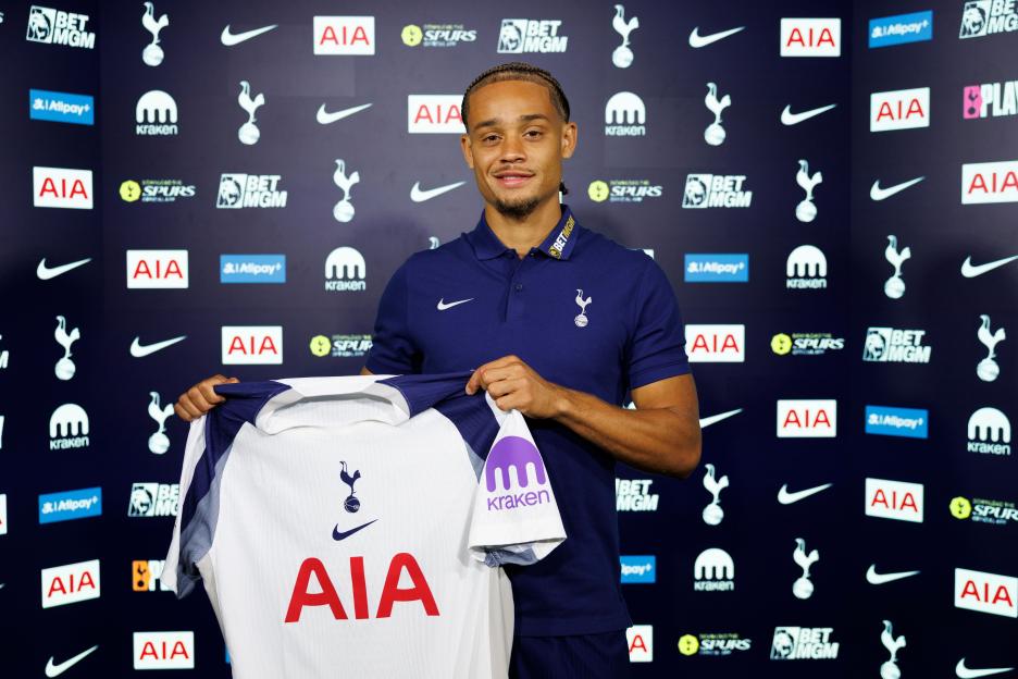 Xavi Simons holding a Tottenham Hotspur jersey.