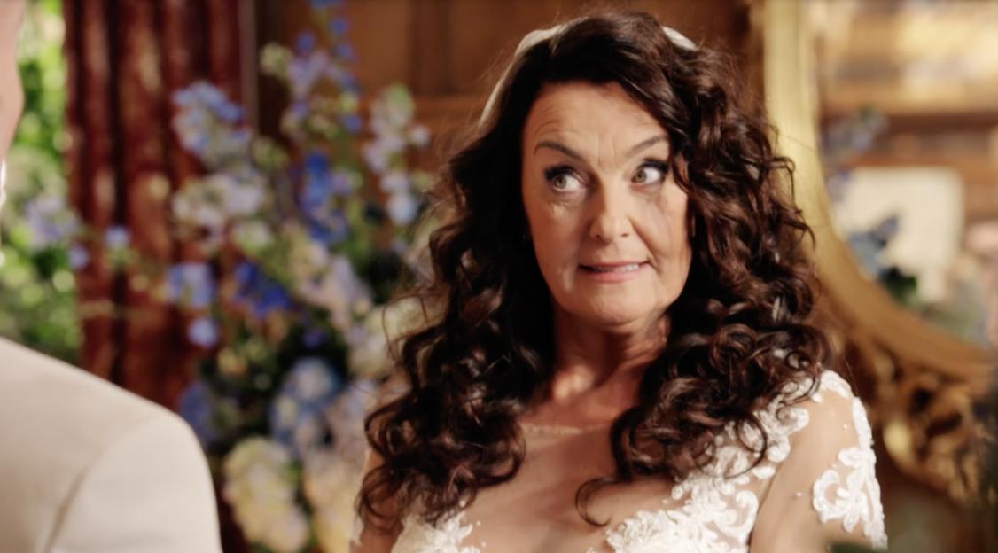 Bride looking surprised at wedding reception.