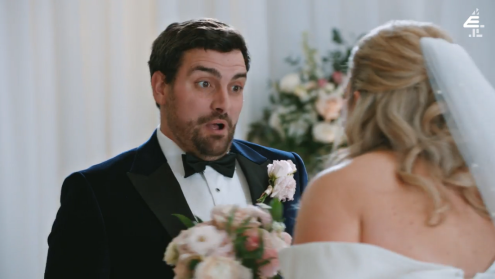 Groom looking shocked at bride.