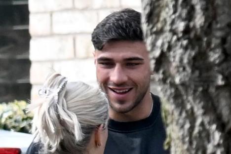 Tommy Fury is all smiles as he reunites with Molly-Mae Hague and baby daughter Bambi after family holiday