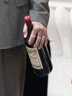 David Beckham holding a bottle of wine.