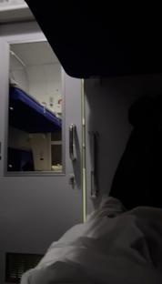 Interior of a train sleeping compartment at night.
