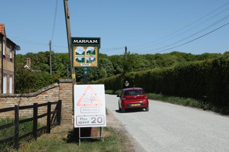Marham village sign and a 20 mph speed limit sign due to skid risk.