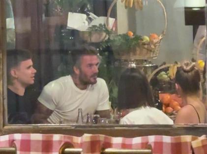 The Beckham family dining at a restaurant.