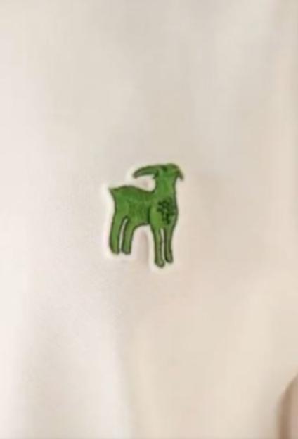 Green goat emblem on cream fabric.