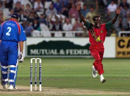 Zimbabwe's Henry Olonga celebrates taking the wicket of England's Chris Adams during a One Day International cricket match.