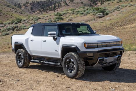 White GMC Hummer EV on a dirt road.