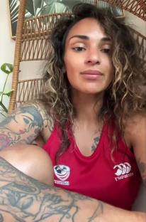 Woman in red rugby shirt speaks to camera.
