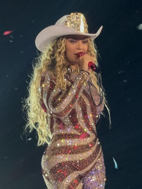 Beyoncé performing in a sparkly bodysuit and cowboy hat.