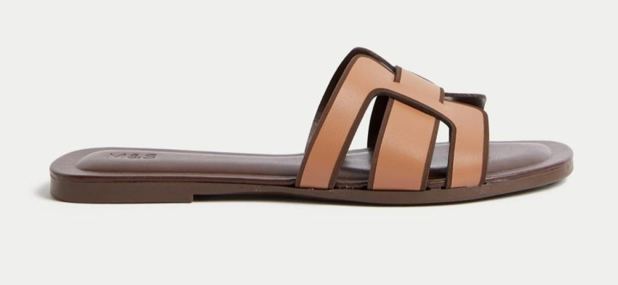 Flat mules with brown and beige straps.