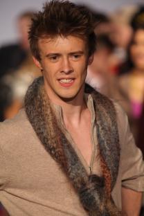 Ruari Cannon walking a runway at a fashion show.