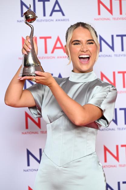 Molly-Mae Hague holding a National Television Awards trophy.