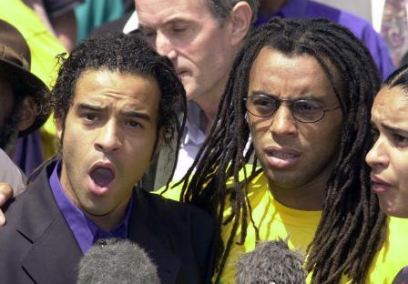 Two men speaking to reporters after their murder convictions were overturned.