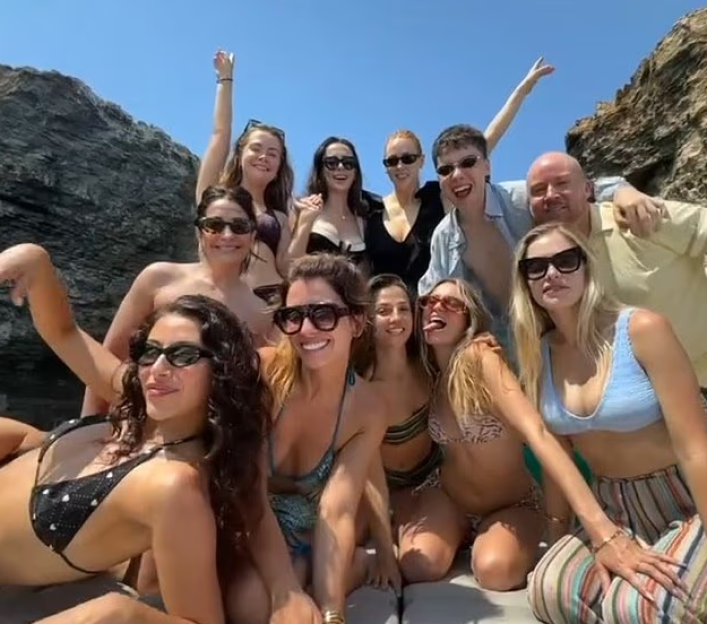Large group of people posing for a photo on a boat.