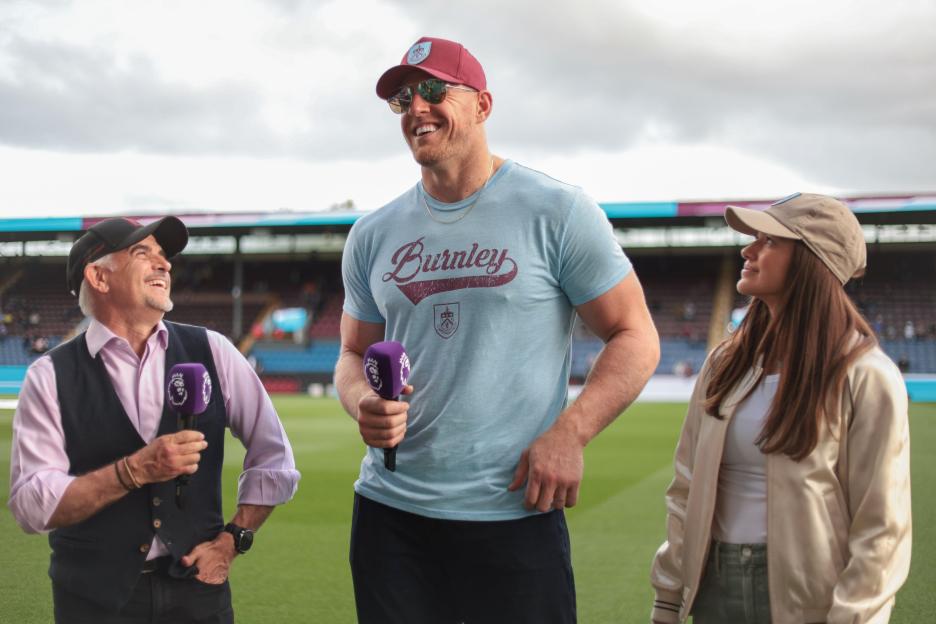 Alun Pace, JJ Watts, and Kealia Watts at the Burnley FC vs. Manchester City FC game.