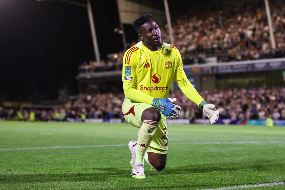 Andre Onana, Manchester United goalkeeper, kneeling on the field.