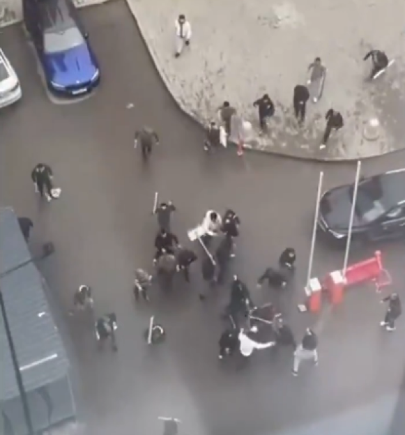 Overhead view of a street brawl involving multiple individuals.
