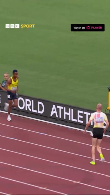 Tim Van de Velde helping Carlos San Martin finish a 3000m steeplechase.