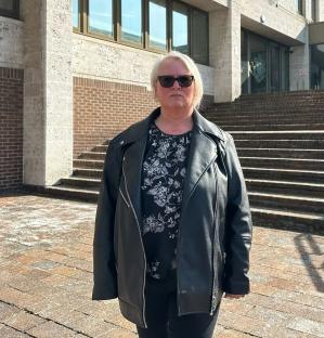 Woman in sunglasses and black leather jacket outside Maidstone Crown Court after winning a child sexual abuse case.