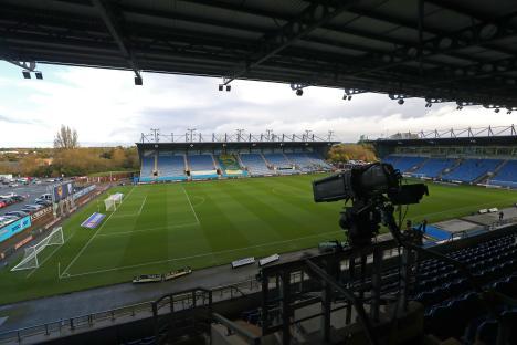 TV camera overlooking a soccer field at The Kassam Stadium.