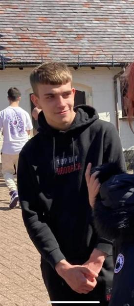 Casey Frasier Coulton wearing a black hoodie with a red and white logo.